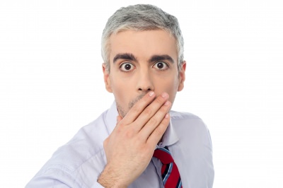 white man with white hair shocked with hand to mouth