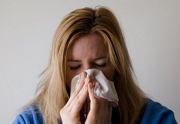 woman wiping nose