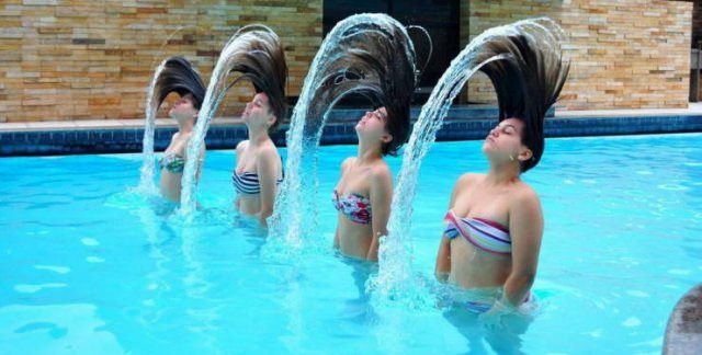 Photo taken at just the right time, four girls coming out of water, flipping their hair in synchronization