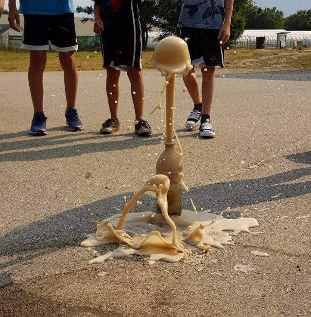 Photo taken at just the right time, coke bottle erupting after adding Mentos