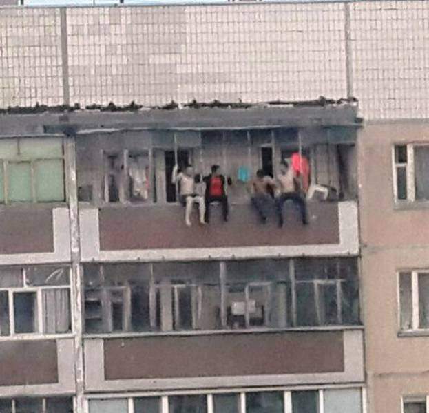 funny pictures of bad ideas, men sitting on railing of a building