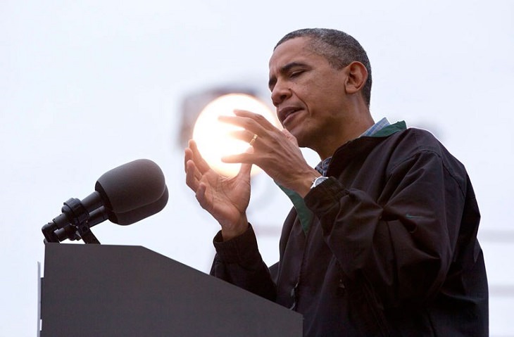 Perfectly-timed Photograph, picture of Obama on stage with a large light in the background that appears to be in his hand