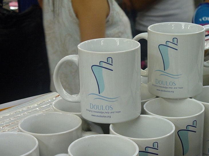 Tips for making the most of your next cruise trip, souvenir white mugs with small blue etching of a cruise ship on them