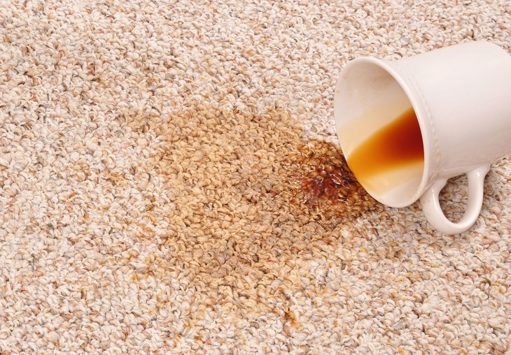 Different Coffee Removal Methods, White coffee mug on its side with spilled coffee on a carpet