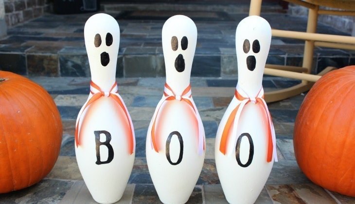Most Incredible Halloween Decorations, Bowling pins with ghostfaces painted on and letters spelling out the word "Boo"