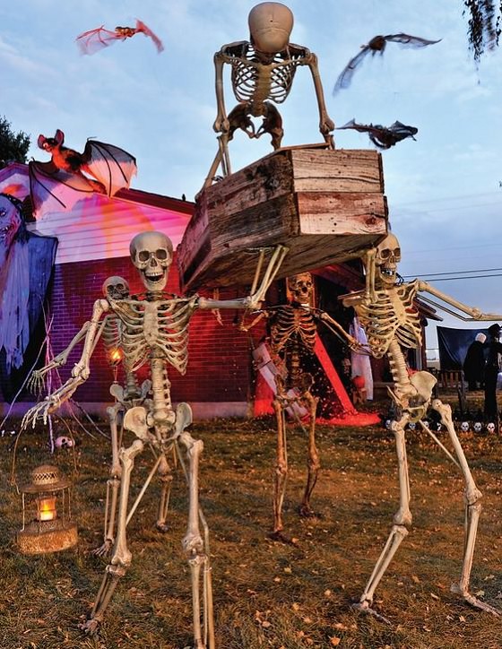 Most Incredible Halloween Decorations, a number of skeletons holding and carrying a coffin