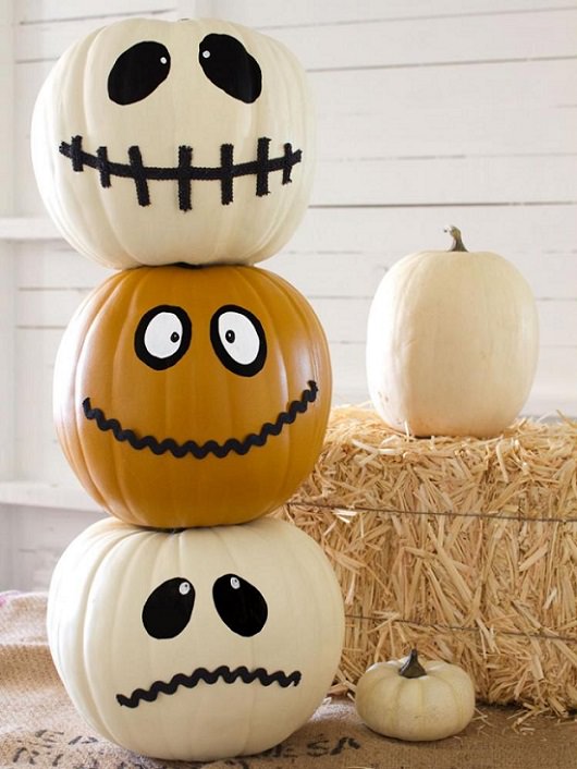 Most Incredible Halloween Decorations, white and orange jack-o-lanterns, semi-smiling