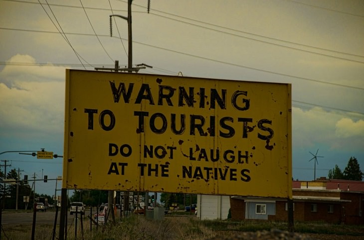 Funny warning and caution signs, warning sign to tourists not to make fun of the natives