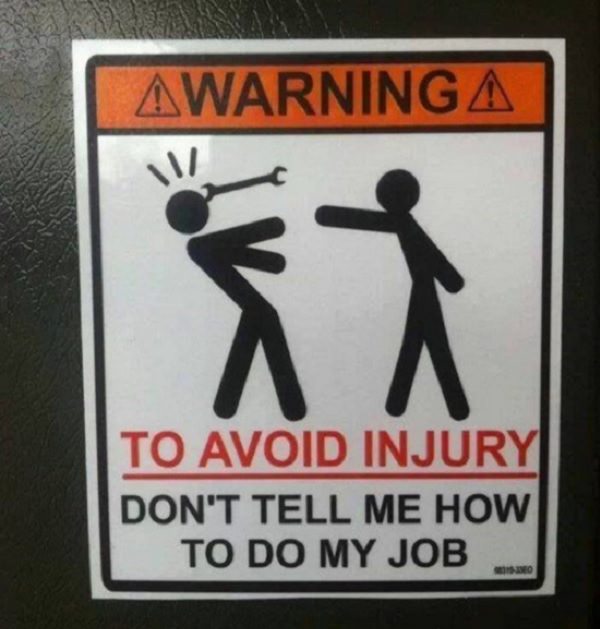 Funny warning and caution signs, funny warning sign of a person throwing a wrench at another stating that injury can be avoided by not telling one how to do their job