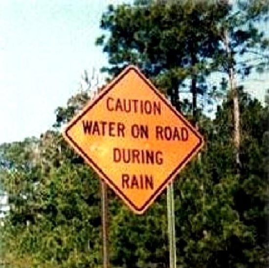 Funny warning and caution signs, caution sign stating that there is water on the road during rain