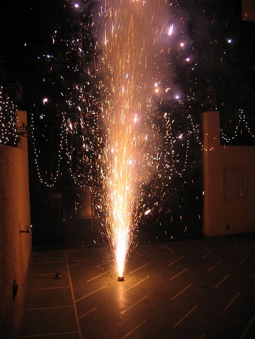 Photos from Diwali, the festival of lights, Another small firecracker for the home, called a flowerpot, that shoots a fountain of sparks upwards when lit