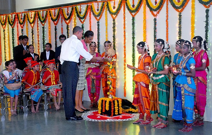 Photos from Diwali, the festival of lights, Barack Obama, US President and First Lady Michelle Obama lighting the lamp to celebrate Diwali in a school in Mumbai, India