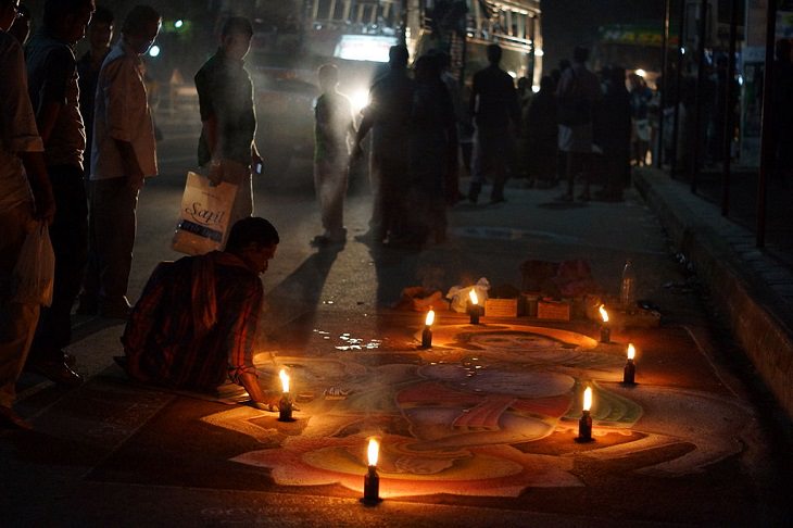 Photos from Diwali, the festival of lights, Lights lit around a drawing of Krishna on the streets at night