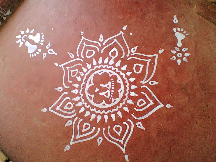 Photos from Diwali, the festival of lights, Kolam drawn with a white paste, instead of the powder