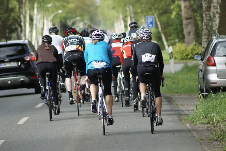 the dutch reach method of opening car doors for safety, group of cyclists cycling on the road