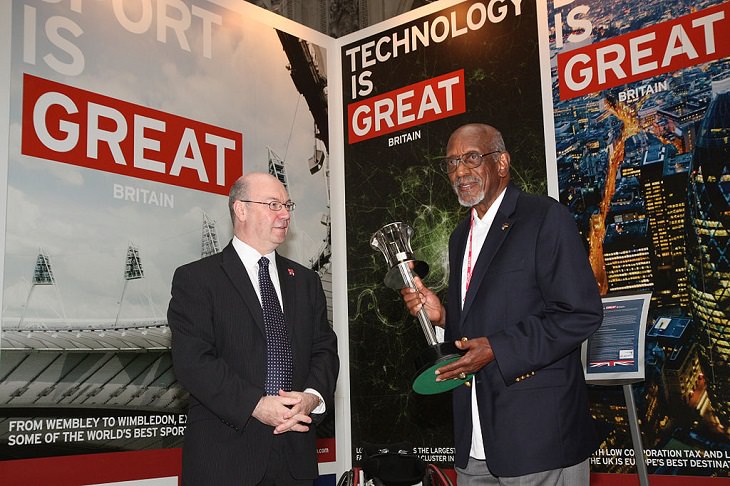 American Athletes that were inducted into the U.S Olympic Hall of Fame, Foreign Office Minister Alistair Burt with Harrison Dillard (track & Field) holding the 1948 London Olympics torch, August 1, 2012