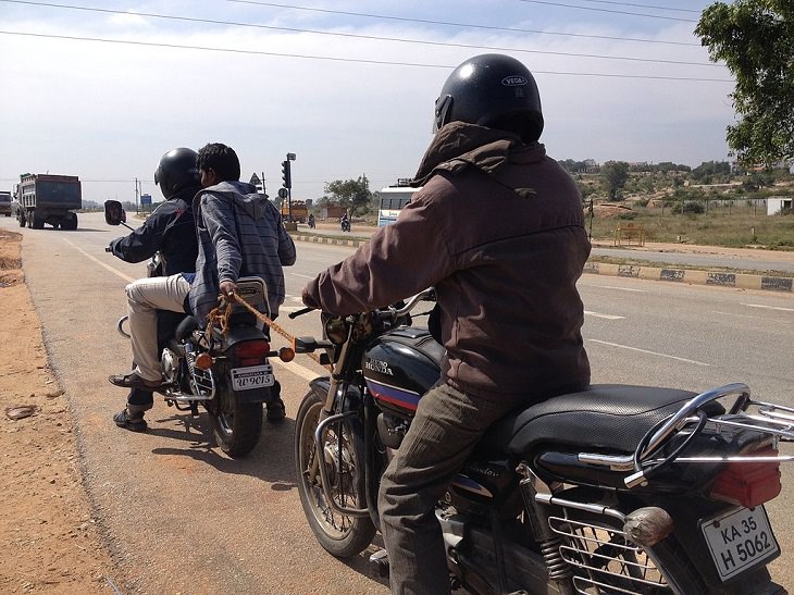 Hilarious but Smart Life Hacks, two men on a motorcycle holding on to a rope pulling another man in a motorcycle behind