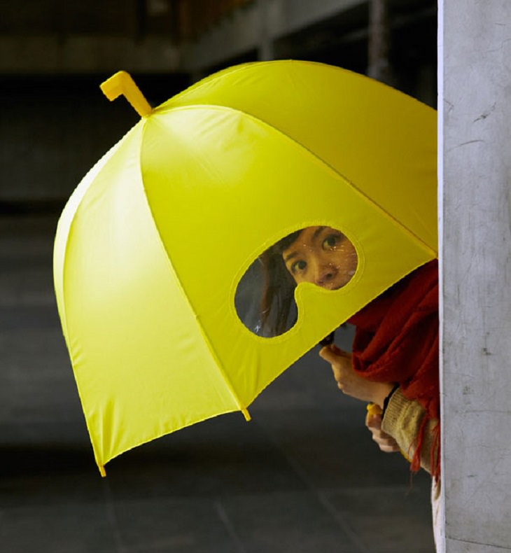Incredible Innovative Design Ideas, child holding yellow umbrella with goggle shape cut out for visibility