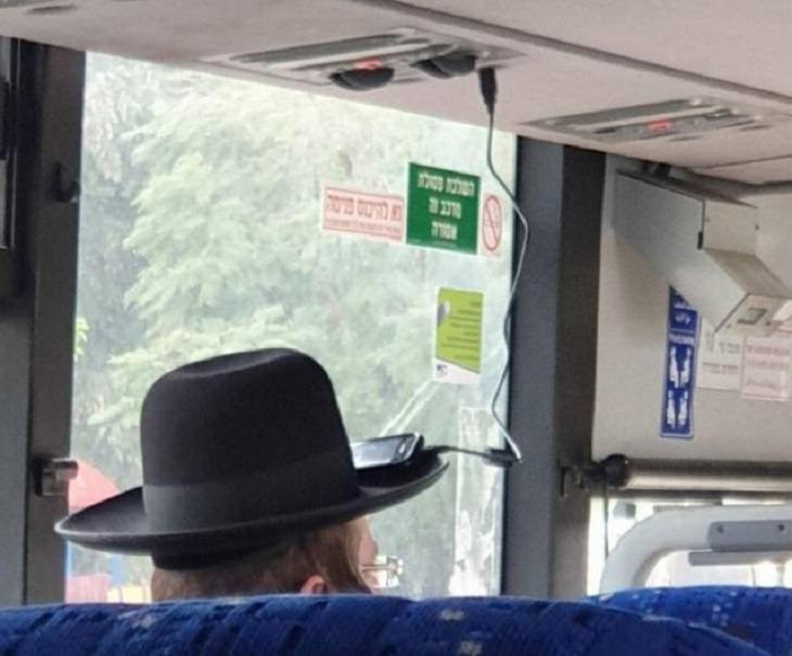 Hilarious but Smart Life Hacks, Man with large hat charging phone on charger over head with phone resting on the rim of the hat