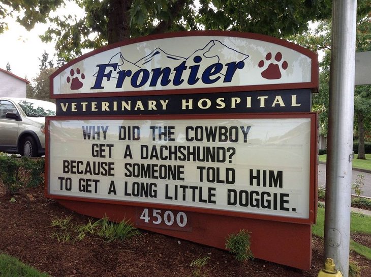 Pet Jokes found on signs outside veterinary clinics and animal hospitals, sign reading "Why did the cowboy get a dachshund? Because someone told him to get a little long doggie", Frontier Veterinary Hospital