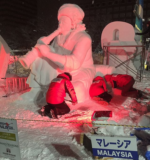 Snow Sculptures and Statues from Festival, The Navy Misawa snow sculpture team sculpting a snow bust of "The Lone Sailor", for the 63rd Annual Sapporo Snow Festival