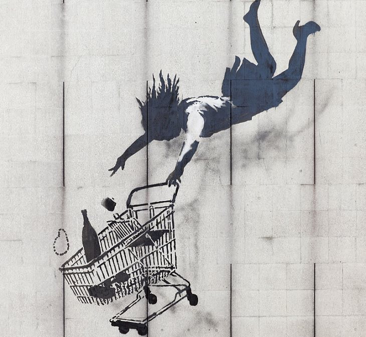 Beautiful Street art and graffiti murals from around the world, Graffiti of a woman with a shopping trolley falling down the side of a building. Items are falling out of the trolley