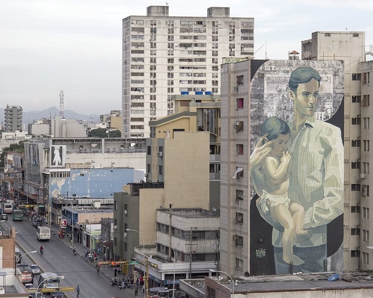 Beautiful Street art and graffiti murals from around the world, Aryz's mural in Venezuela (2015), young man in a white striped shirt holding an infant