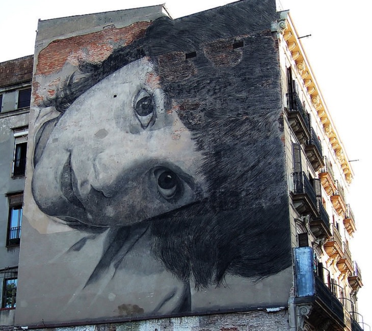 Beautiful Street art and graffiti murals from around the world, mural on a building wall in black and white of a young girl's face