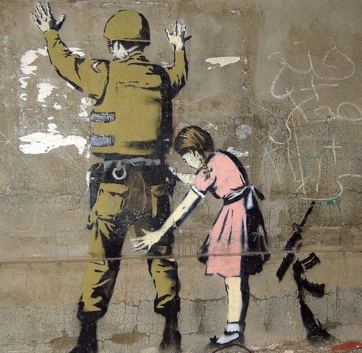 Beautiful Street art and graffiti murals from around the world, mural of a young girl patting down a soldier who has his back turned to her and his arms raised