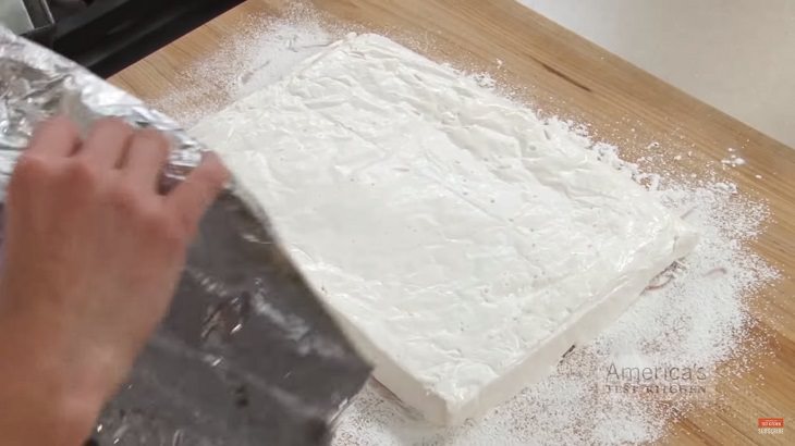 Perfect Recipe for Homemade marshmallows, marshmallow rectangle being placed onto cutting board