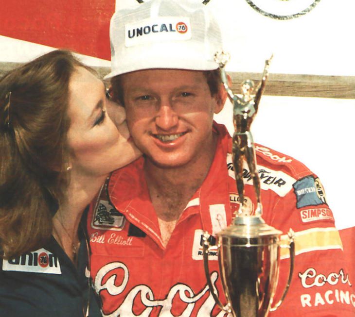 Top 19 NASCAR Race Drivers to Win Multiple Tracks, Bill Elliott, after he won the Budweiser 500 at Dover Downs International Speedway in 1985, being a kissed by a girl on the cheek
