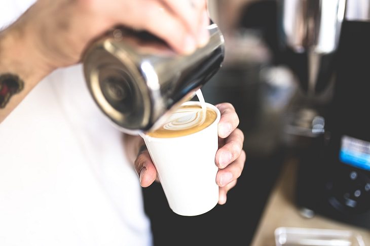 DIY homemade coffee creamer, person pouring creamer into a cup with coffee