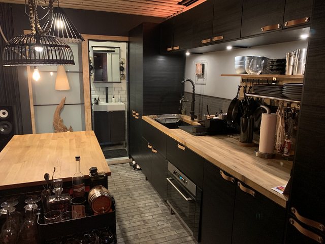 Will Breaux builds a house out of Eleven Shipping Containers, completed kitchen of the house, with shelves and utensils