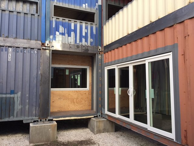 Will Breaux builds a house out of Eleven Shipping Containers, windows and doors for the bottom containers while still in construction