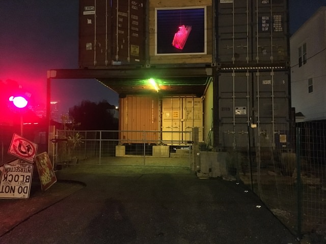 Will Breaux builds a house out of Eleven Shipping Containers, view of the house, signs and lighting of the ship container house from outside