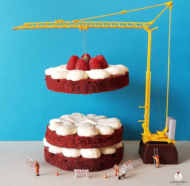 Beautiful Cakes Designed by Italian Chef, Two layers of red velvet cake with white icing with the third layer suspended above by a yellow crane
