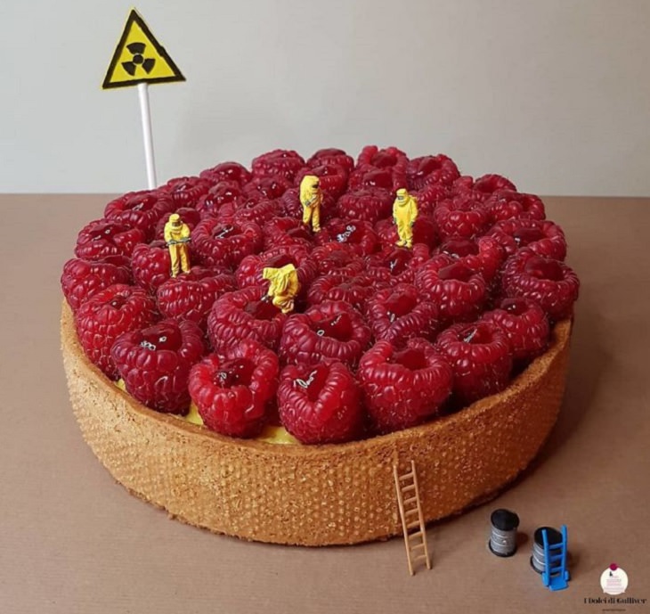 Beautiful Cakes Designed by Italian Chef, Cake with raspberries and hazmat warning sign and 4 small figurines in yellow hazmat suits