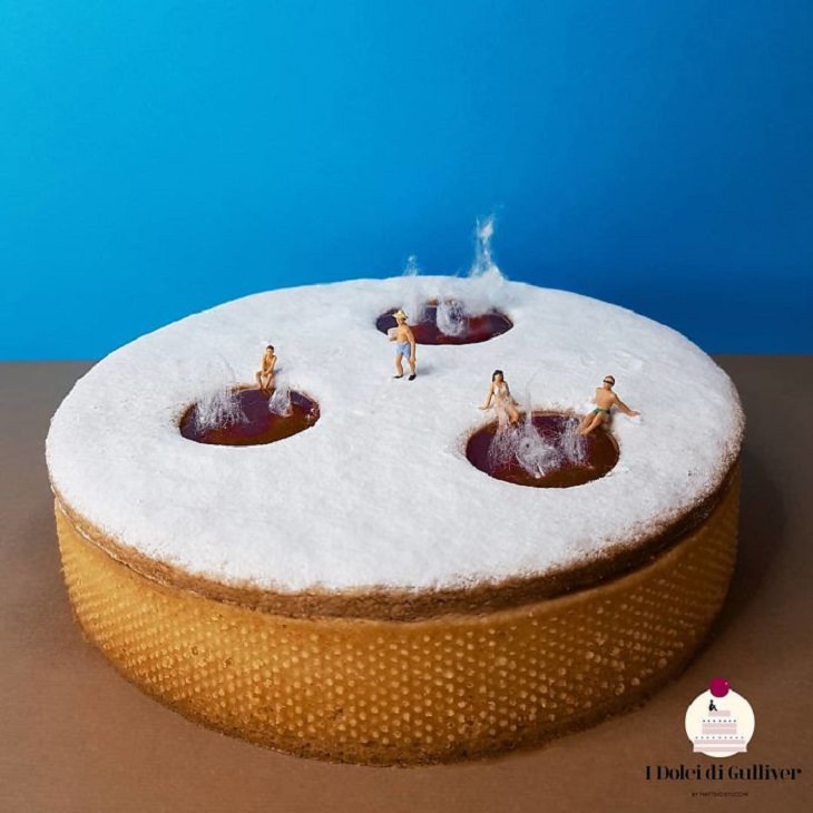 Beautiful Cakes Designed by Italian Chef, Vanilla cake with sugar powder on top and three large circles with chocolate on the top and small figurines sitting in them, resembling a hot springs