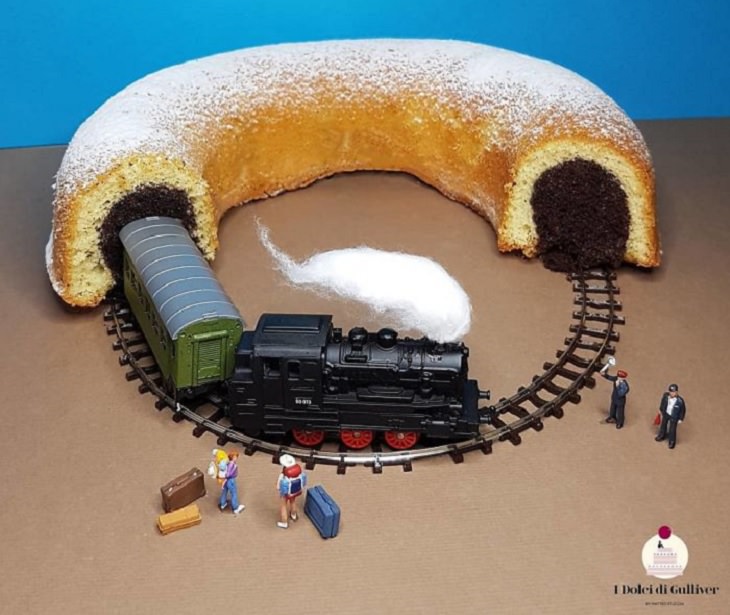 Beautiful Cakes Designed by Italian Chef, Chocolate filled cake cut in half with a train on tracks coming out the open ends.