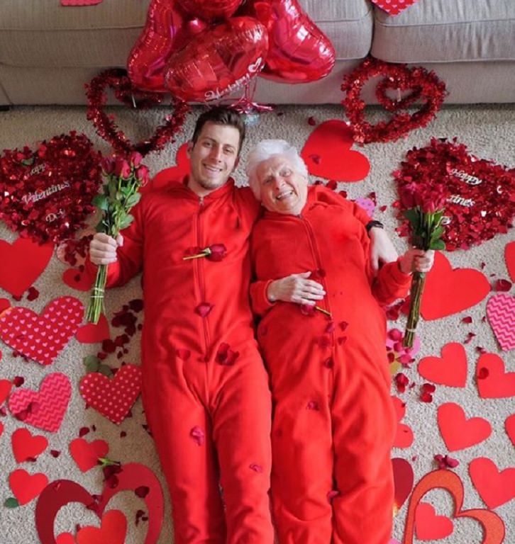 duo of grandmother and grandson, ross smith, wear fun costumes for social media, wearing red with cut out hearts all around