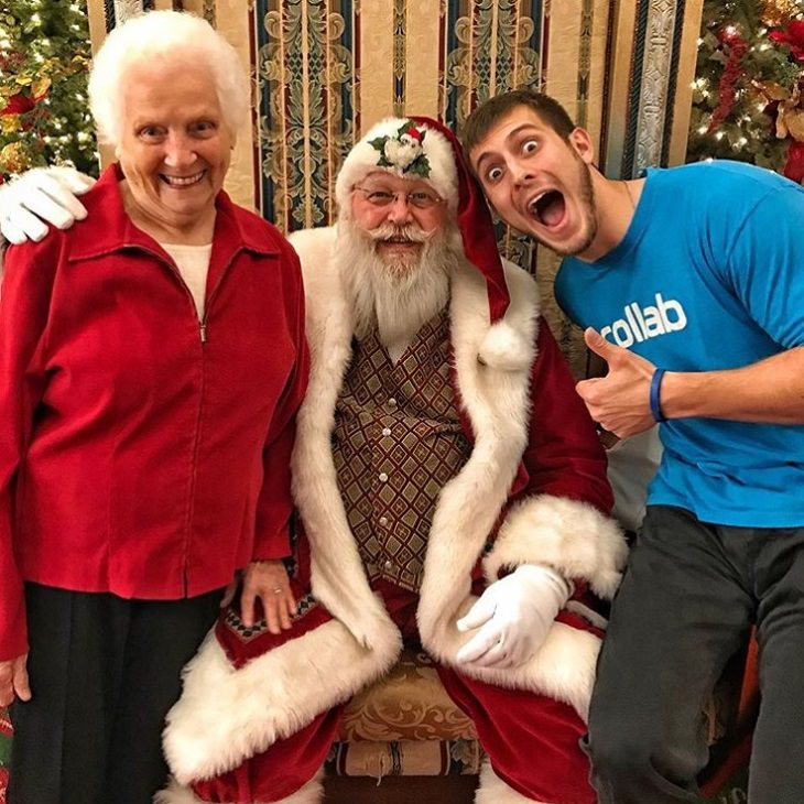 duo of grandmother and grandson, ross smith, wear fun costumes for social media, dressed in red with santa claus