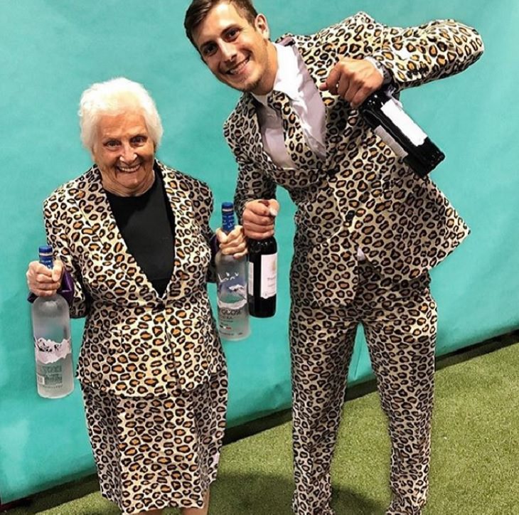 duo of grandmother and grandson, ross smith, wear fun costumes for social media, wearing animal print suits