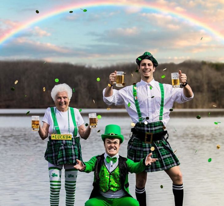 duo of grandmother and grandson, ross smith, wear fun costumes for social media, in front of a rainbow dressed in green costumes