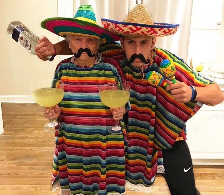 duo of grandmother and grandson, ross smith, wear fun costumes for social media, dressed in rainbow ponchos holding maraca's and margaritas