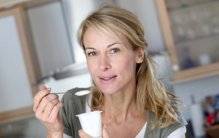 effects of aging on digestion woman holding yogurt