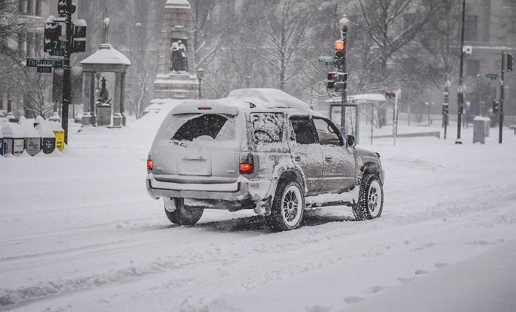 Helpful Winter Life Hacks On a Budget for dealing with Ice, Frost and Snow, car covered in snow on the road