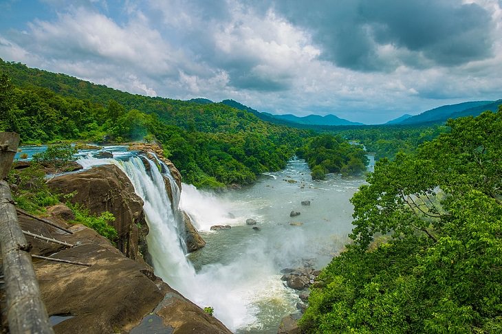 Sights and must-see destinations in the tourist state in India, Kerala, also known as God’s Own Country, Athirapally falls as it crashes into the Western Ghats