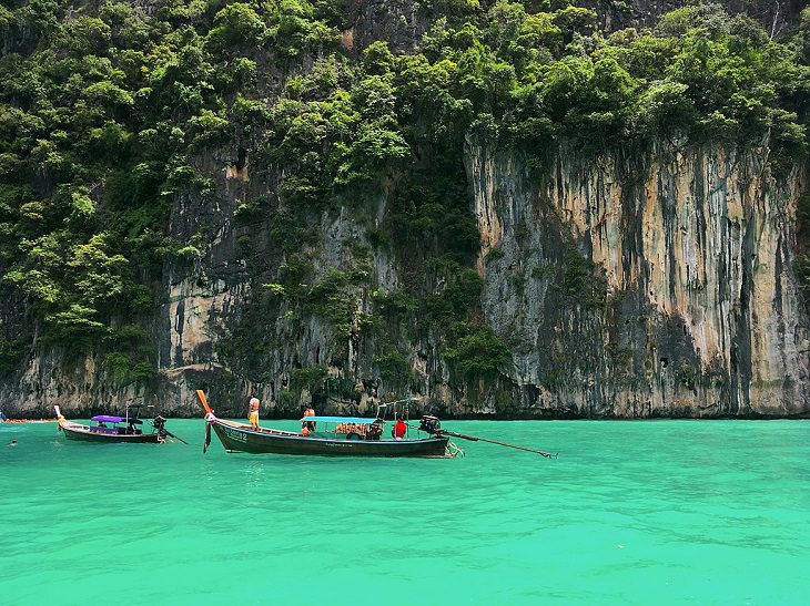 The sights, destinations and fun activities of cultural hub and land of beaches, Krabi in Thailand, Going for a ride in a long-tail boat in Pileh Lagoon in the Phi Phi Islands
