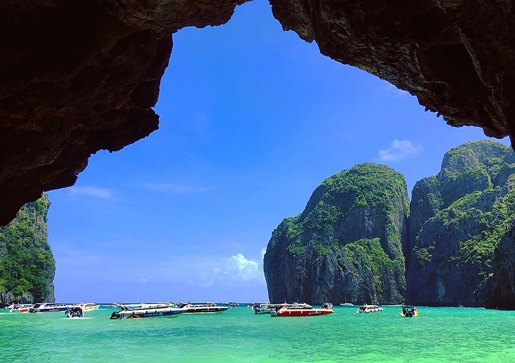 The sights, destinations and fun activities of cultural hub and land of beaches, Krabi in Thailand, Speed boats and yachts on Maya Bay, in Phi Phi Le (Phi Phi Islands)