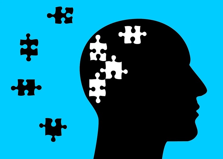 Debunking the myths about mental health, silhouette of head in front of blue background with puzzle pieces removed